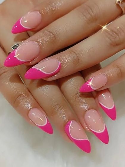 A modern and sharp design with a bright pink asymmetrical tip on long stiletto nails.
