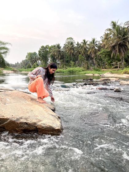 Reaching down to touch the water. Simple gestures can create a powerful connection to the elements.