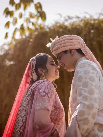 A low-angle shot capturing the couple about to share a kiss. The natural light from above creates a soft, romantic mood, emphasizing their intimacy.