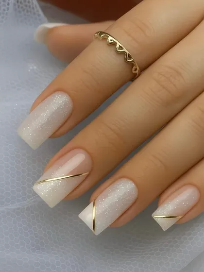 This is the kind of perfection we aim for. A clean, elegant bridal nail set with a shimmering base and a delicate gold line accent. Mastering these classic looks is a core part of my nail technician training.