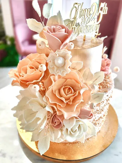 Celebrating a milestone like a 25th anniversary calls for something truly special. I spent hours hand-sculpting each petal of these delicate sugar flowers to create a cascade of timeless elegance on this two-tier cake.