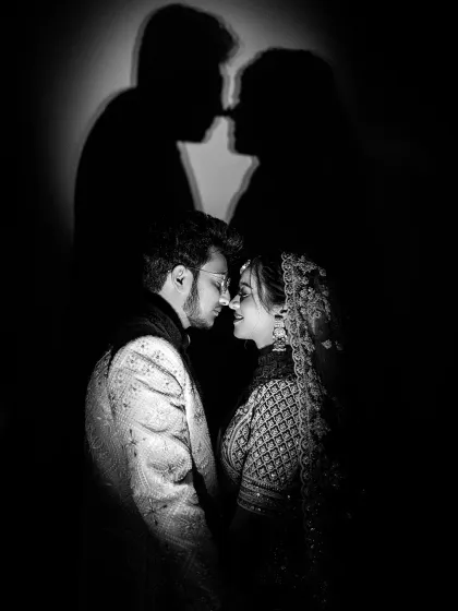 Playing with shadows to tell a deeper story. This creative couple portrait uses silhouettes to represent the beautiful connection and unity between two people, creating a powerful and artistic wedding photograph.
