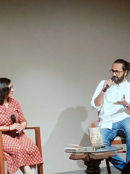 A candid shot from a book discussion. An author shares insights while in conversation, creating an engaging atmosphere for the audience.