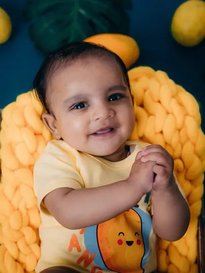 A sweet, happy expression from this 4-month-old cutie. The mango theme is perfect for a summer baby photoshoot.