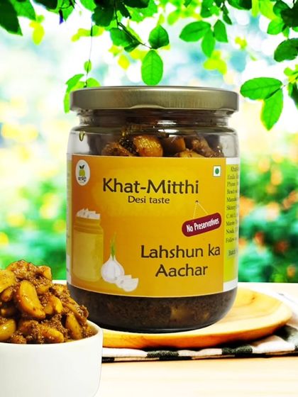 A jar of my Lahsun ka Achaar, with whole cloves of garlic pickled in a tangy and spicy masala. It's great for your health and tastes amazing.