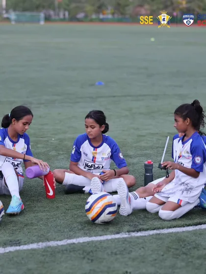 More than a team, we are a family. Our young players taking a moment to rest and bond during a training session, highlighting the friendships and camaraderie built at our academy.