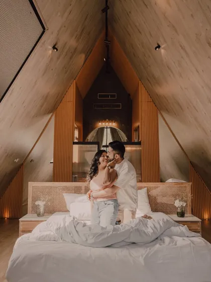 An intimate pre-wedding moment, away from the world. We believe the best photos happen when you can just be yourselves. This cozy, cinematic shot in a beautiful A-frame cabin captures the couple's quiet love and connection.