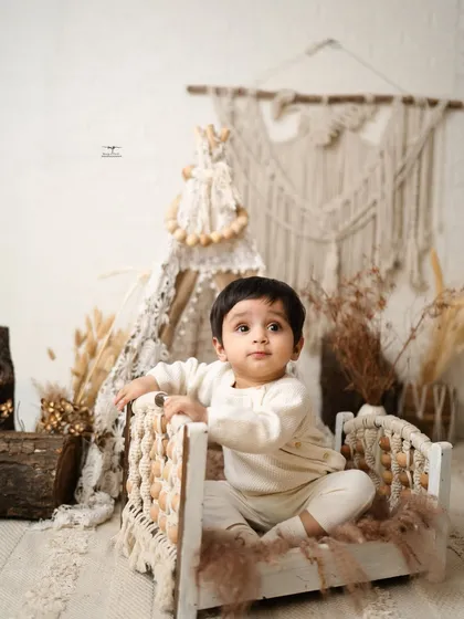 This baby boy looks so sweet and curious sitting in a miniature beaded bed. Sitter sessions are perfect for capturing this inquisitive stage.