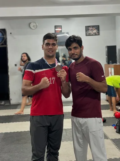 A coach's pride is in his student's success. Here I am with Vaibhav, celebrating his hard-earned bronze medal. This is the result of countless hours of disciplined training.