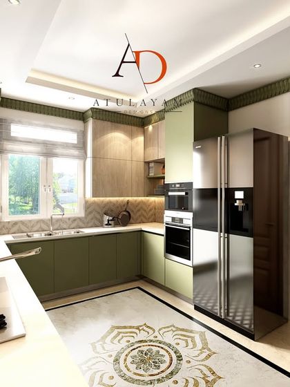 A modern dual-tone kitchen in olive green and a light wood laminate. The design includes a beautiful marble inlay on the floor, adding a touch of luxury.