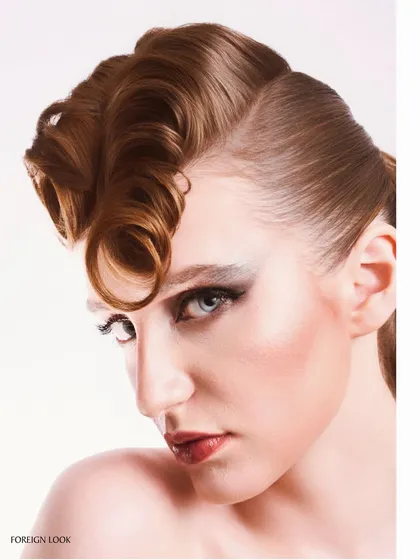 A close-up detail shot of the sculpted hair and makeup, demonstrating precision in both the styling and the photography.
