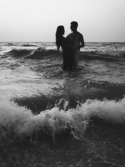 A dramatic black and white seascape from an engagement session. Standing together against the vastness of the ocean creates a powerful, moody photograph that feels both epic and deeply personal.