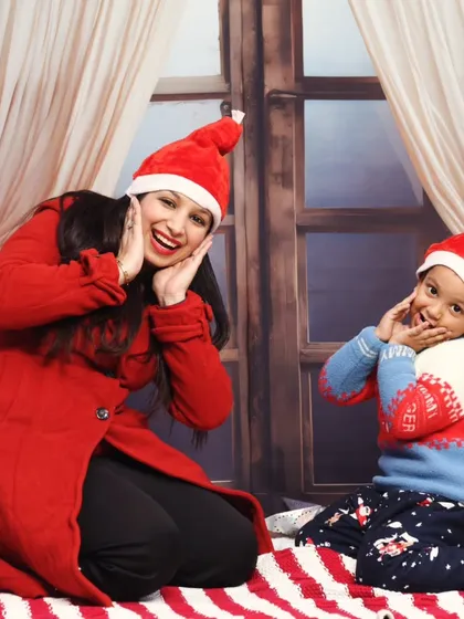 Mother and son making funny faces for the camera in our Christmas-themed studio.