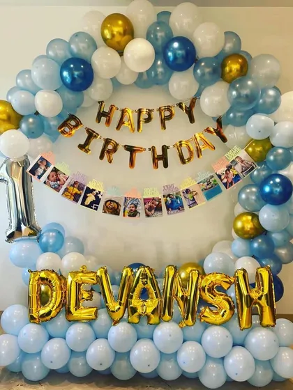 This version of the decoration includes a photo banner with pictures from the baby's first year, adding a personal touch.