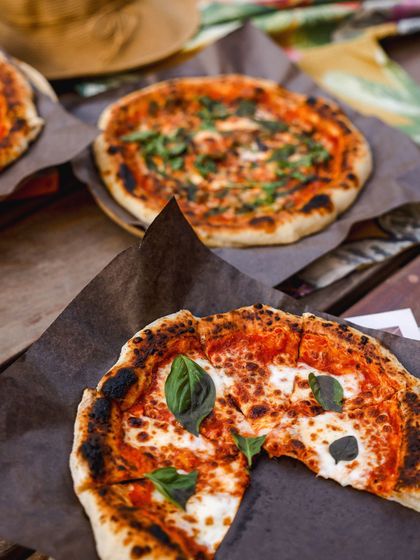 A spread of our artisanal pizzas, perfect for sharing with friends and family.