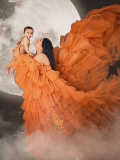 A creative composite image showing a mother and baby flying towards the moon, a truly magical and imaginative portrait.