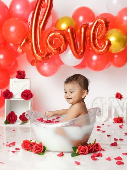 Celebrating love with a Valentine's Day themed splash session. The "LOVE" balloon and scattered rose petals create a wonderfully festive and sweet atmosphere.