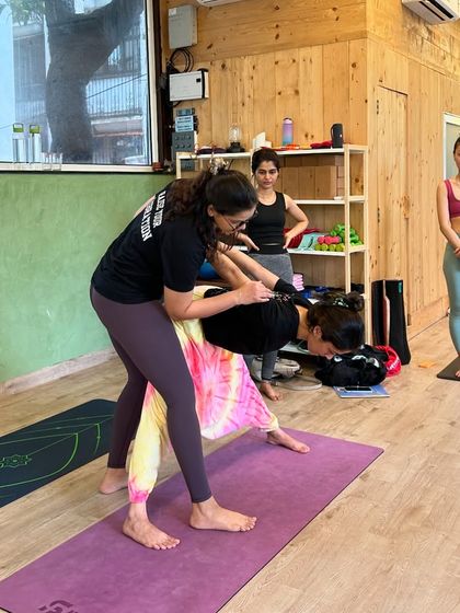 A closer look at an adjustment for Trikonasana (Triangle Pose). We're guiding the student to create more length in the side body and open the chest, a fundamental skill for any yoga teacher to master.