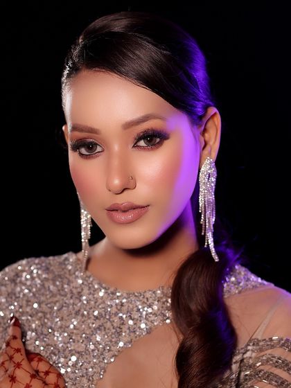 This look is all about sparkle and confidence. The model wears a sequined silver dress, and the makeup features a dramatic smokey eye and glowing skin, perfect for a night out.
