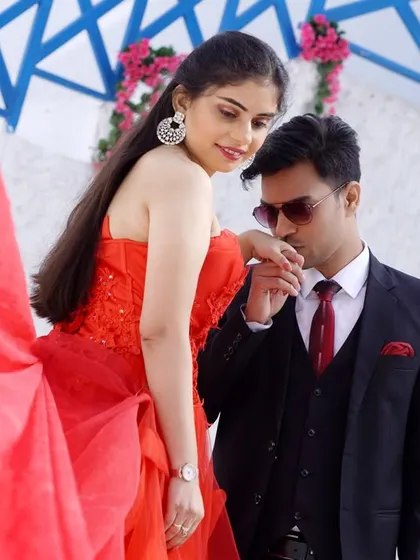 A gentle kiss on the hand is a timeless romantic gesture. This shot captures the elegance and affection of the couple.
