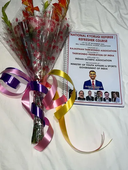 The official course material and a bouquet I received at the referee seminar in Rajasthan.