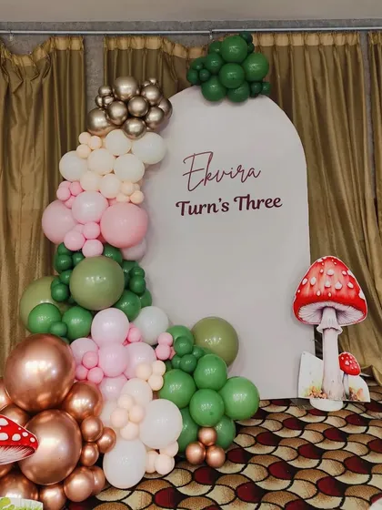 A close-up of the balloon arch and backdrop for the fairy theme.