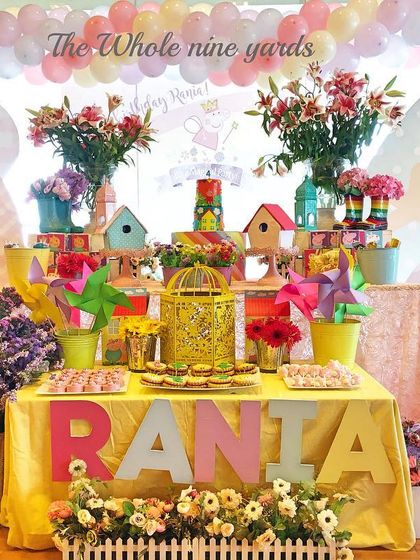A cheerful Peppa Pig party with a dessert table full of flowers and bright colors. I designed it to feel like a happy day in Peppa's garden.