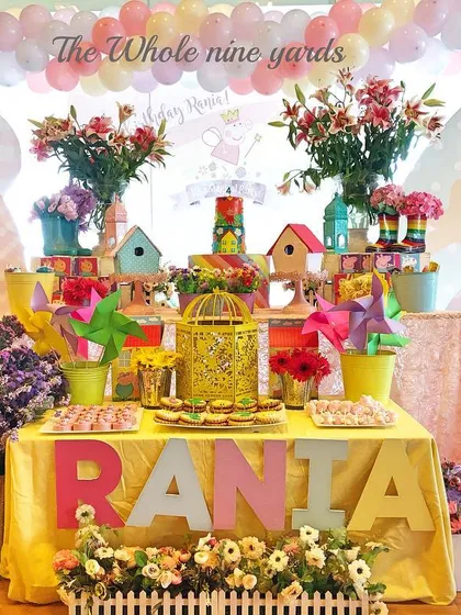 A cheerful Peppa Pig party with a dessert table full of flowers and bright colors. I designed it to feel like a happy day in Peppa's garden.