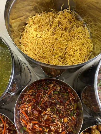The components for Chinese Bhel, including crispy noodles and tangy sauce.