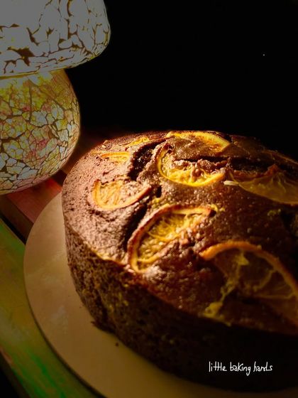 A rich chocolate and orange whole wheat cake, beautifully lit. The cake is even better than the picture.