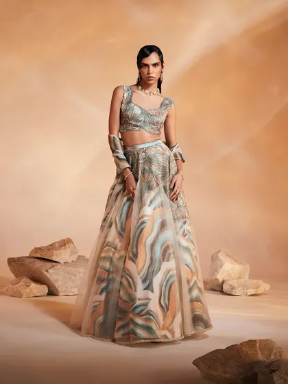 The Ivy Lehenga Set, designed for shimmery nights and glamorous days. This full look shows the organza layered lehenga with its embroidered motif and hand-embellished blouse.