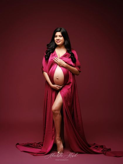 This flowing satin gown in a deep magenta hue drapes beautifully, creating a look of pure elegance and confidence.