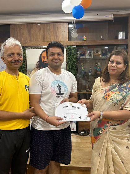 A student from the "Early Risers" team receives his certificate, showcasing the pride and joy of being part of our community events.