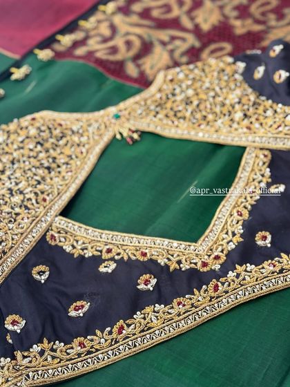 A black and green blouse with a heavily embroidered back design.