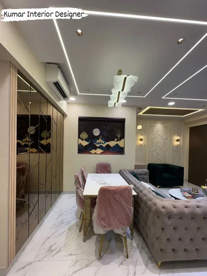 The dining area is defined by a mirrored wall and a statement chandelier, creating a bright and luxurious space for family meals.