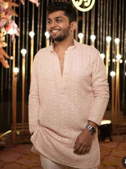 A simple yet elegant short kurta in a dyed light peach color. The Lakhnavi fabric with subtle sequin work makes it perfect for an evening Sangeet or festive gathering.