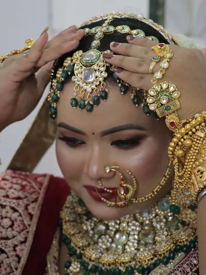 The bride adjusting her headpiece, giving a clear view of the detailed craftsmanship of her bridal accessories.