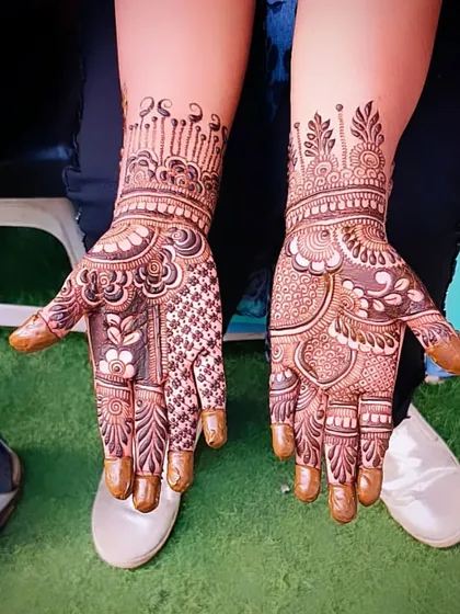 Another example of a traditional henna design, showcasing full coverage and a variety of patterns.