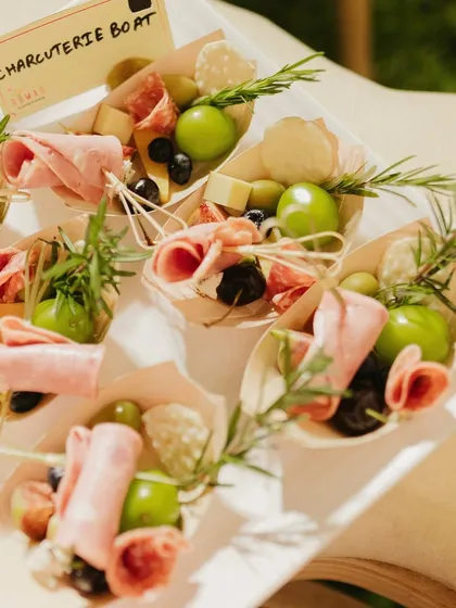 Perfect for mingling, my individual charcuterie boats are a guest favorite. Each boat is a personal treasure of cured meats, fresh grapes, olives, and cheese, garnished with rosemary. It's a sophisticated and convenient way to enjoy gourmet bites.