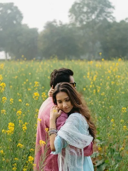 A romantic embrace in a vast field of yellow mustard flowers, capturing the feeling of being lost in their own world.