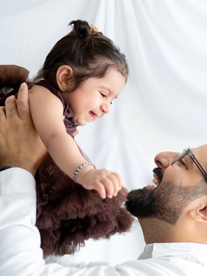The pure joy of a dad playing with his daughter. I love capturing these high-energy, happy moments that show the fun side of family life.