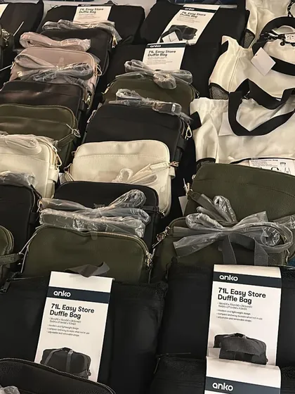 A look at all the items sourced from a trip, including crossbody bags and duffle bags. Each item is carefully checked before being sent out.