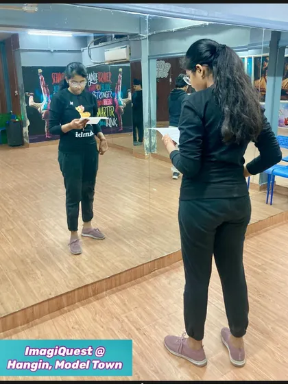 A student practices her monologue in front of the mirror for our "Shaking Shakespeare to Life" theatrical. This mirror work is a key technique we use to help actors refine their expressions and body language.