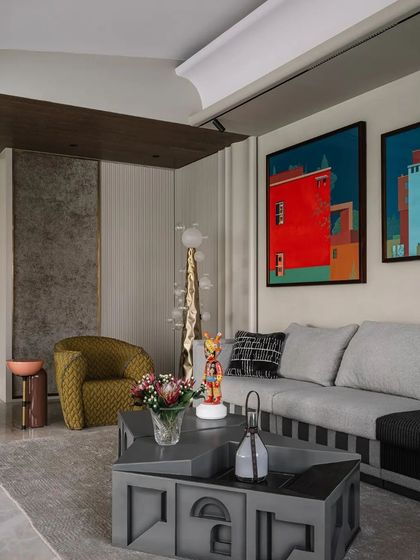 Another view of the living area, showcasing the layering of art, furniture, and textures to create a rich and personalized interior.