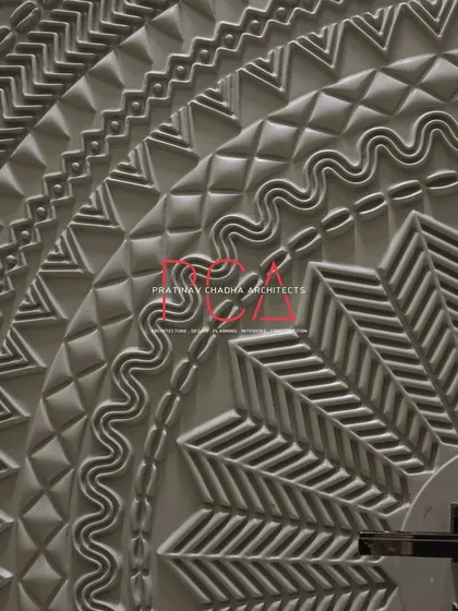 A detailed close-up of the CNC-milled main door, focusing on the handle and the surrounding patterns. The craftsmanship brings a unique, tactile quality to the entrance of the home.
