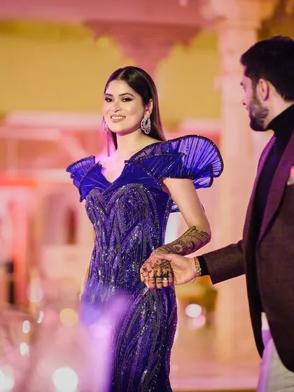 A glamorous cocktail night look for my bride Kashish in Udaipur. We went for a bold, structured gown and paired it with a sophisticated makeup look featuring shimmering eyes and a sleek hairstyle, showing the transition from traditional ceremonies to modern evening parties.