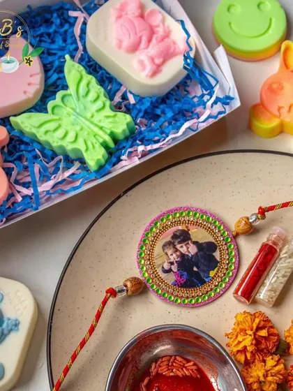Celebrating the special bond between siblings with my Rakhi collection. This image displays a variety of colorful, kid-friendly natural soaps in fun shapes like Hello Kitty and Mickey Mouse, paired with a beautiful, personalized photo Rakhi.