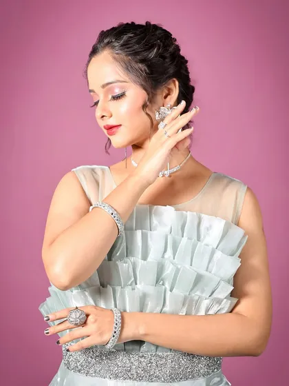 The intricate details of the ruffled bodice and the elegant hairstyle this gown pairs with. It's a complete look ready for any special occasion.