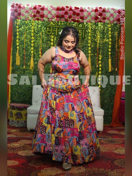 The full look of the bride's vibrant Mehndi lehenga. The riot of colors and prints perfectly captures the festive spirit of the ceremony.