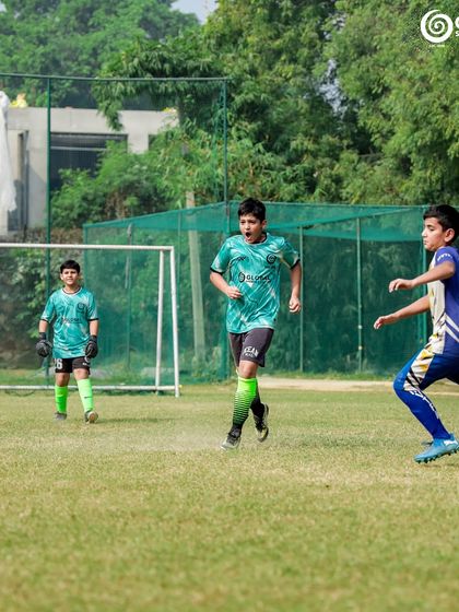 A GSC player runs onto a loose ball with the goal in the background.